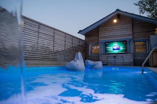 a swimming pool with icebergs in front of a house at Spa Villa Skaloma in Nafpaktos