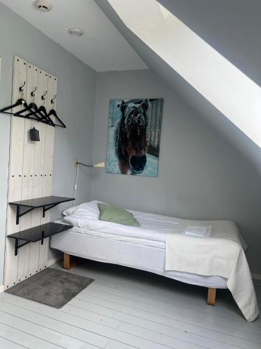 a bedroom with a bed with a picture of a dog at Hallamölla Gård in Brösarp