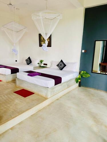 a bedroom with two beds in a room at Blue Mountains View in Dambulla