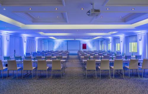 a large room with rows of tables and chairs at NH Collection Plaza Santiago in Santiago