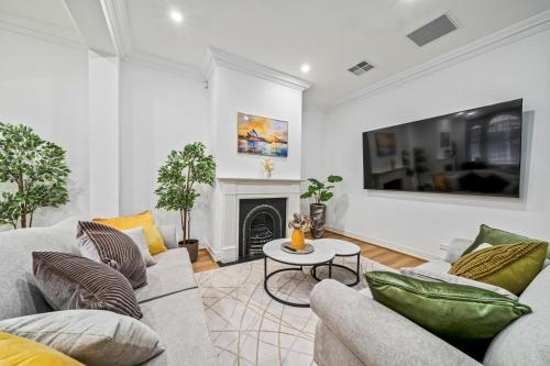 a living room with a couch and a fireplace at Luxe Living Terrace by The Star in Sydney