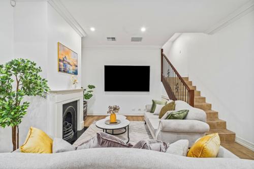 a living room with two couches and a tv at Luxe Living Terrace by The Star in Sydney