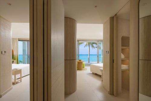 a hotel room with a view of the ocean at Centara Mirage Lagoon Maldives in Nakachchafushi