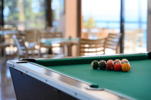 a pool table with four balls on top of it at Siora Leni Hotel in Benitses