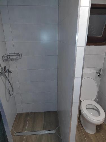 a small bathroom with a toilet in a stall at E79 AQUALUNA KAMP NATURA PODČETRTEK card not included in Podčetrtek