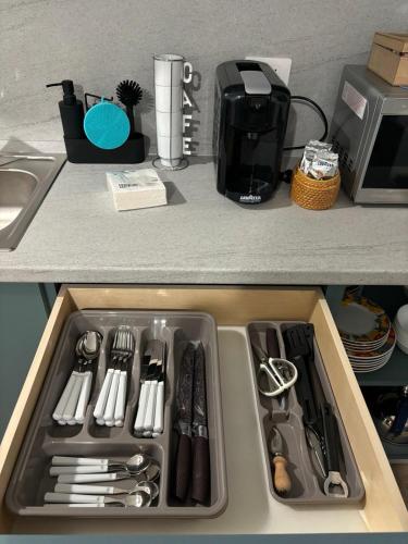 a sink with utensils in it in a kitchen at Come a Casa in Vittuone