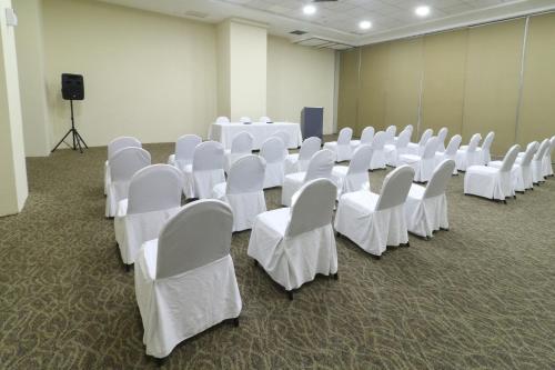 a room with rows of white chairs and a podium at Holiday Inn Express Ciudad Del Carmen by IHG in Ciudad del Carmen