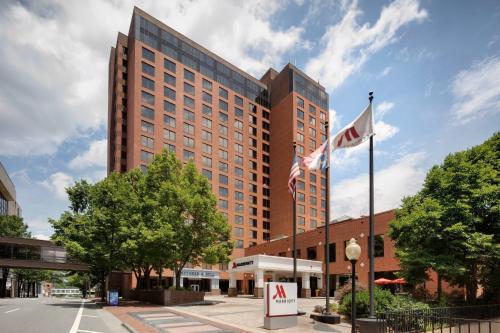 a tall building with two flags in front of it at Winston-Salem Marriott in Winston-Salem
