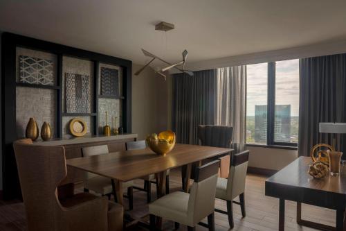 a dining room with a wooden table and chairs at Winston-Salem Marriott in Winston-Salem