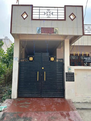 a building with a black garage door with stars on it at Home near Holy Mahakumbh in Prayagraj