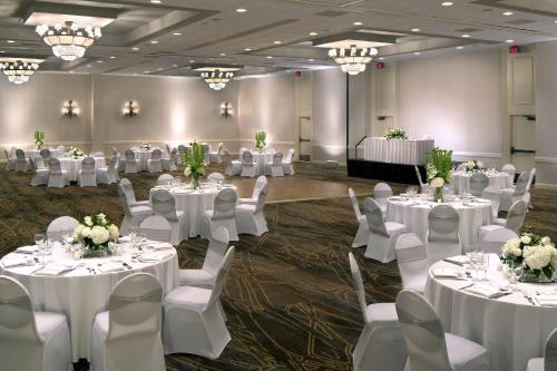 a banquet hall with white tables and chairs and chandeliers at Winston-Salem Marriott in Winston-Salem