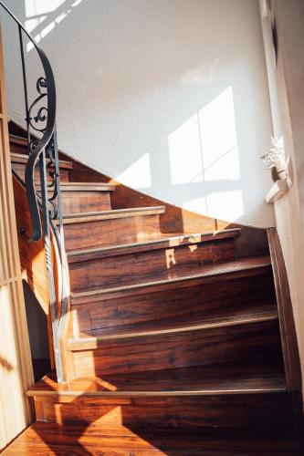 a staircase with wooden steps with a window at Hotel Haus am See in Nonnenhorn