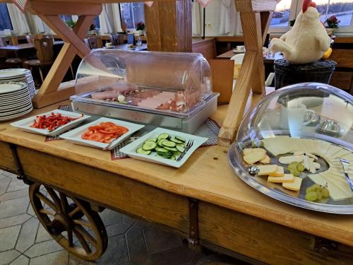 a table with different types of food on it at Landpension Pferdekoppel - B&B - Self Checkin in Seewald
