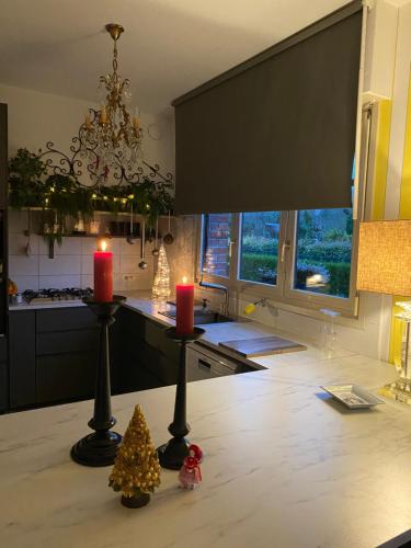 a kitchen with two candles and christmas trees on a counter at L’hirondelle du Faubourg in Saudemont