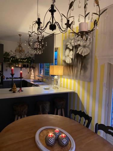 a dining room with a table with candles on it at L’hirondelle du Faubourg in Saudemont