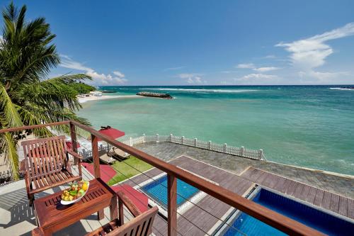 a balcony with a view of the ocean at Garton's Cape in Ahangama
