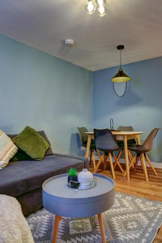 a living room with a couch and a table at The Bailey - Troon - Coorie Doon Stays in Troon