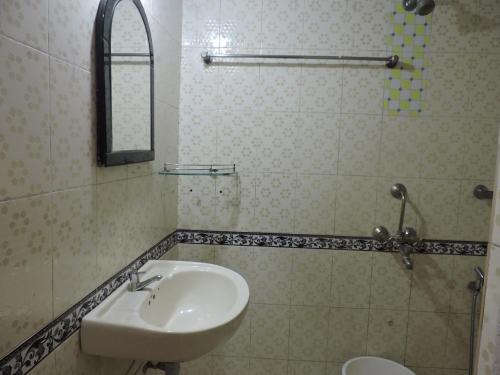 a bathroom with a sink and a mirror at Zappia Cove Resort Palolem in Palolem