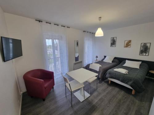 a living room with a couch and a table at Hotel Bains Sarrailh in Dax