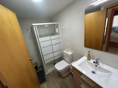 a bathroom with a toilet and a sink and a mirror at LV Aquario I in La Pineda