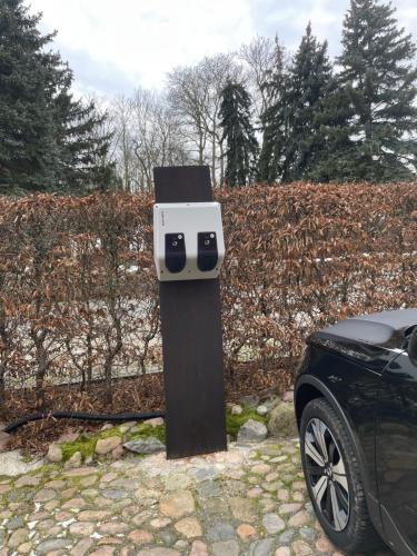 a car parked next to a wooden post with a camera on it at Rittergut zu Groitzsch in Jesewitz