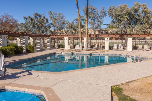 a swimming pool in a courtyard with a building at Cozy House Pool Spa Tennis & Pickleball Courts in Tempe