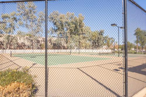 a chain link fence around a baseball field at Cozy House Pool Spa Tennis & Pickleball Courts in Tempe