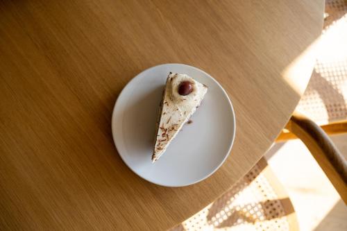 a piece of food on a plate on a table at Hotel Haus am See in Nonnenhorn