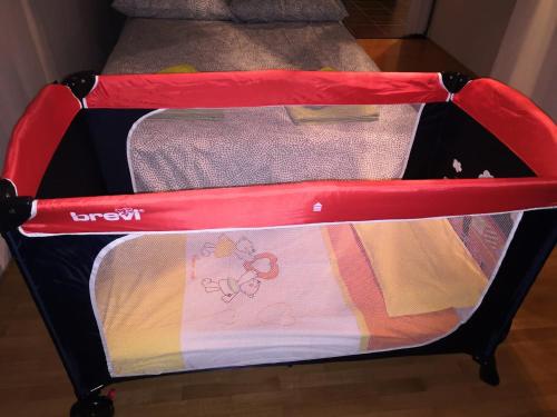a red and black suitcase with clothes in it at Rododendro 29 - Ciclovia Alpe Adria APT with Terrace in Tarvisio