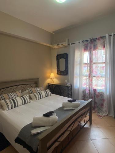 a bedroom with a large bed with towels on it at Happinest Private Apartment II in Kalymnos