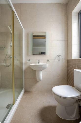 a bathroom with a toilet and a sink and a shower at Elegant central apartment in Sliema