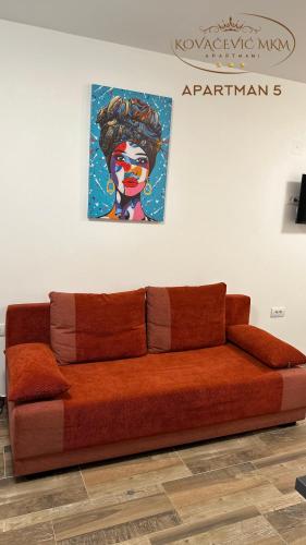 a couch in a room with a painting on the wall at Apartmani Kovačević MKM Banja Vrujci in Gunjica