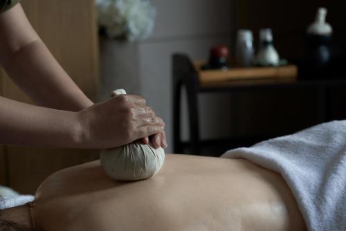 a woman with her hands on a ball of clay at Dongguan DongCheng International Hotel - Free shuttle buses for executive room guests during Canton Fair in Dongguan