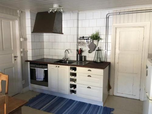 a kitchen with a sink and a counter top at Barnebo 3-6 in Blomstermåla