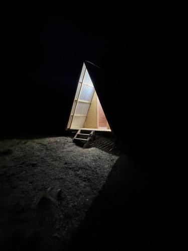 a small building with a door in the dark at Camping Arroyo Quila Seca in Futaleufú