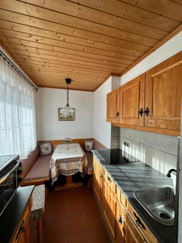 a kitchen with a table in the middle of it at Lilly Chalet- Apartments with private sauna, close to ski lifts in Bad Kleinkirchheim