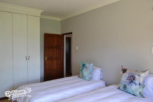 two beds sitting next to each other in a bedroom at The Yems in Dullstroom