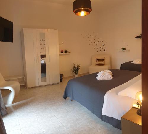 a bedroom with a bed and a chair in it at Santa Filomena Guest House in Terni