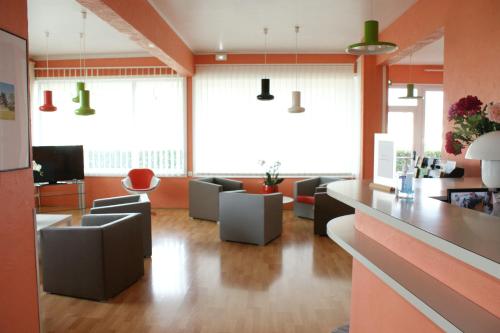 a lobby with couches and a living room at Hotel Val Vert in Pouilly-en-Auxois