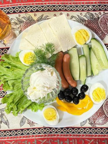 a plate of food with eggs and vegetables on a table at Golden Kapan in Kapan