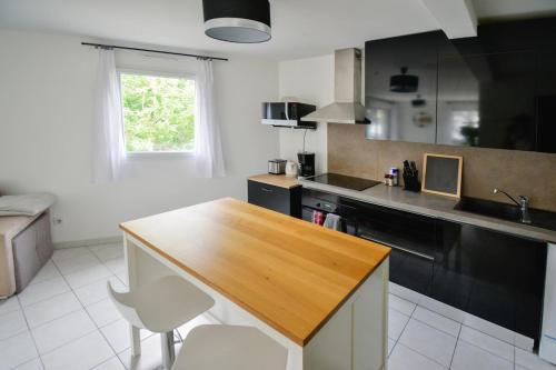 une cuisine avec un comptoir en bois et un évier dans l'établissement Le Préville avec terrasse et parking gratuit, à Montpellier