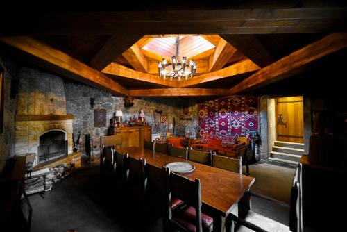 a dining room with a table and a fireplace at Villa Dudu, Luxury Villa in Hankavan in Hankʼavan