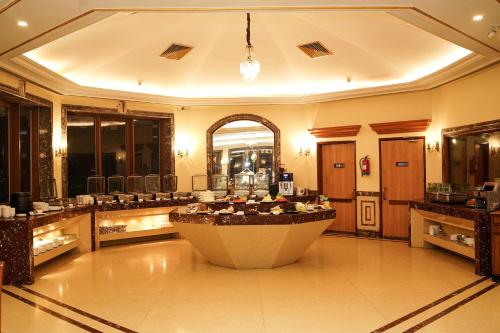 a large bathroom with a large tub in the middle at Ambassador Ajanta Hotel, Aurangabad in Aurangabad