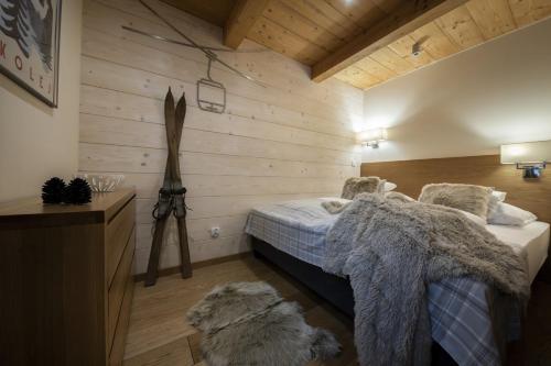 a bedroom with a bed and a dog laying on the floor at Apartamenty Kuźnice 13 in Zakopane