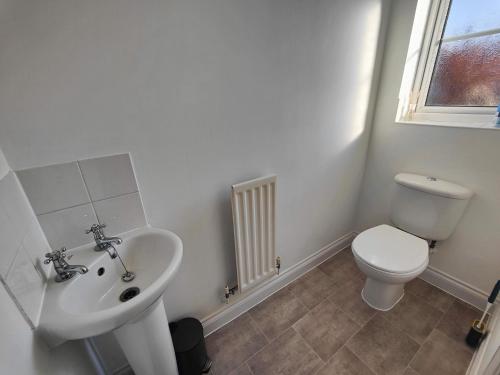 a bathroom with a sink and a toilet at Cedar - AwayOnBusiness in Eastleigh