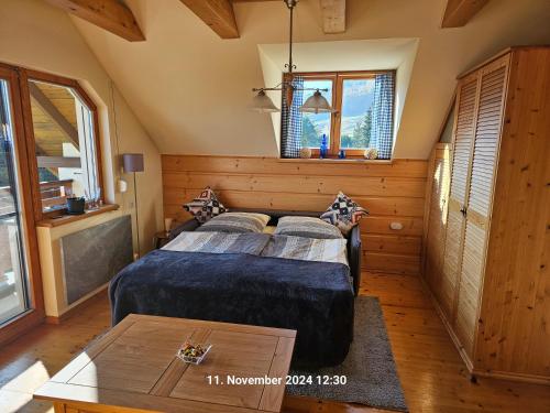 a bedroom with a bed and a table in it at Ferienhaus Lipowa in Lipowa