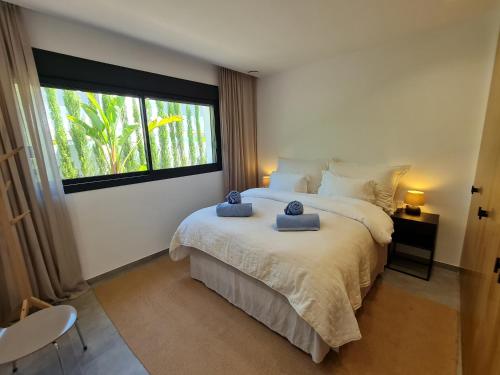 a bedroom with a bed with two towels on it at Villa Benimaurell Relax Beach Moraira in Moraira