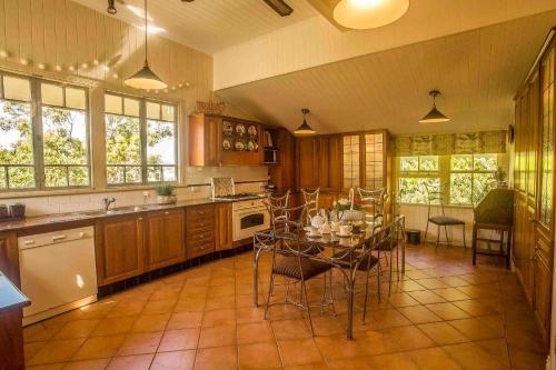 a large kitchen with a table and chairs in it at The Falls Montville in Montville