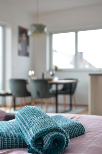 a blue towel sitting on top of a bed at Schwarzwald Lahr Europapark Penthouse Sunshine in Lahr