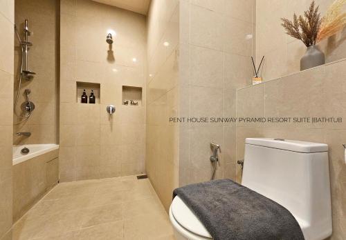 a bathroom with a toilet and a shower and a sink at Sunway Resort Suite #29 1- 6paxs Sunway Lagoon Pyramid in Petaling Jaya